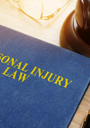 Personal Injury Lawyer - Personal injury law on a desk and gavel.